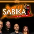 Group of six people posing for a Sabika Festival poster, standing under an orange neon frame with the festival logo above them.